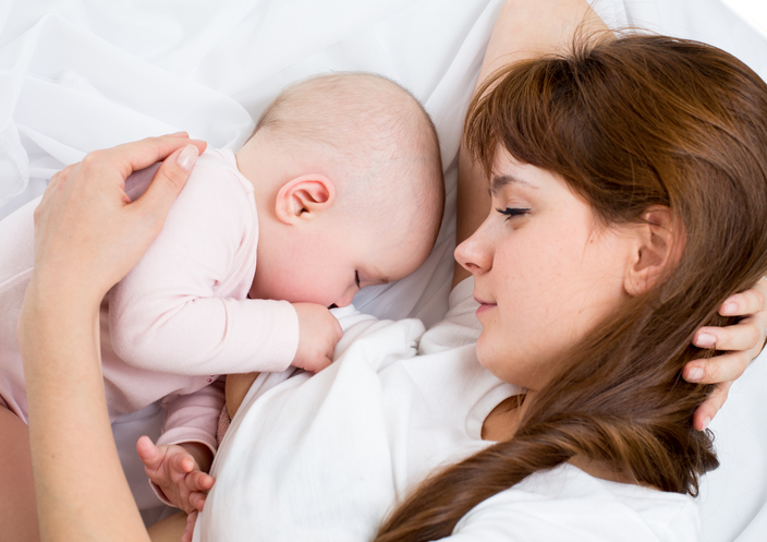 young mother breast feeding her baby girl