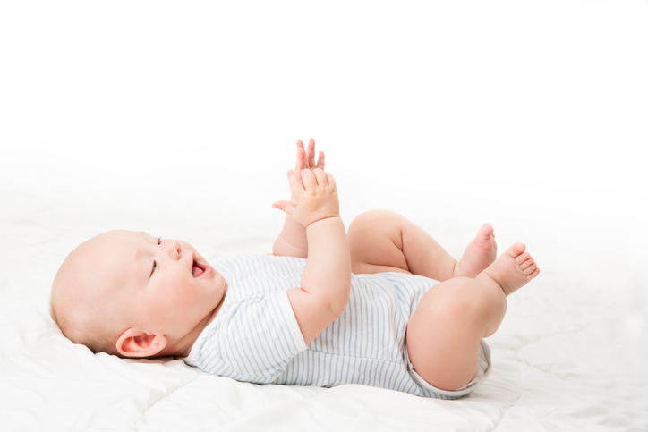 Baby Lying on Back, Happy Infant Kid in Blue Bodysuit, Beautiful Child Lie over White blanket