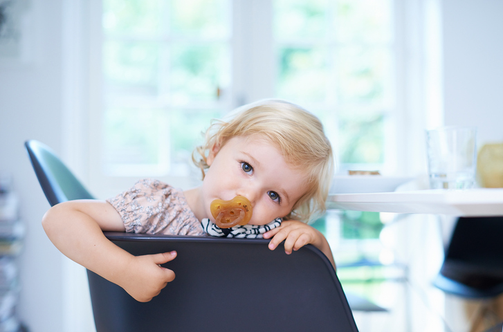 Portrait tired female toddler in living room