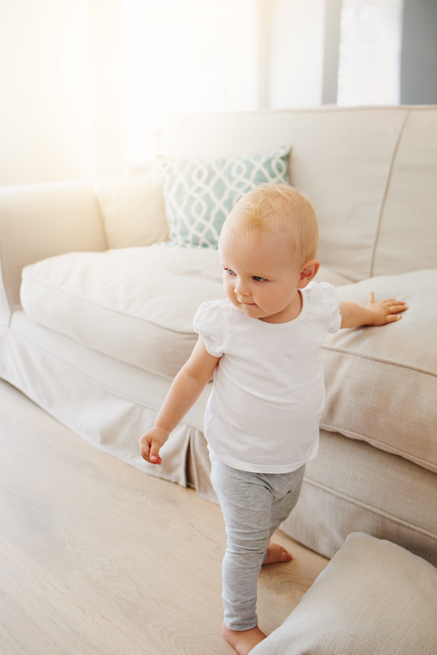 Shot of an adorable baby girl learning to walk at home