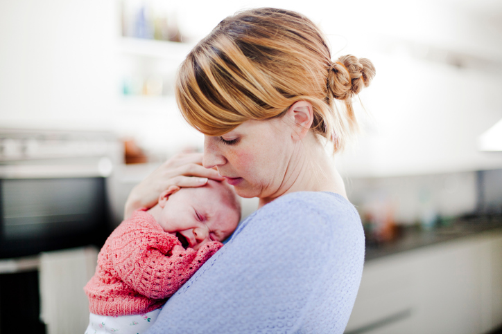 Mother holding newborn daughter